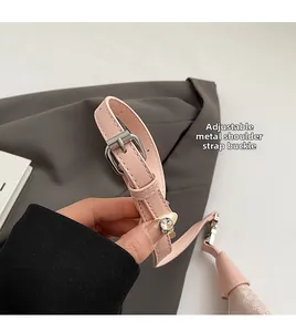 Detail of pink leather strap with adjustable silver metal buckle and multiple holes