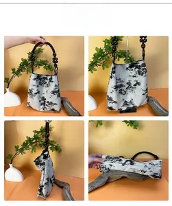Detail of traditional Chinese ink wash landscape print and wooden beaded handles on a tote bag