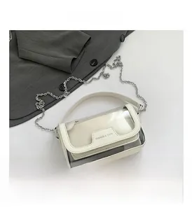 Detailansicht der cremefarbenen Kettentasche mit doppellagigem PVC-Design und Text