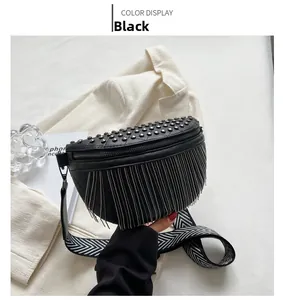Detail of black crossbody bag with silver studs, metal tassels and geometric wide strap