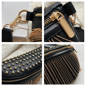 Detail of black quilted leather saddle bag featuring gold studs and chain fringe