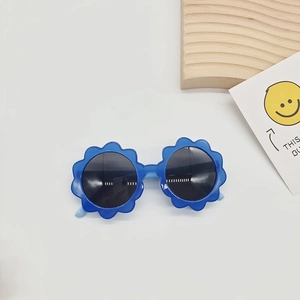 Close-up of blue flower-shaped sunglasses for kids with round lenses on a white background