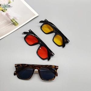 Detailed flat lay of vintage square sunglasses in black and tortoiseshell finishes