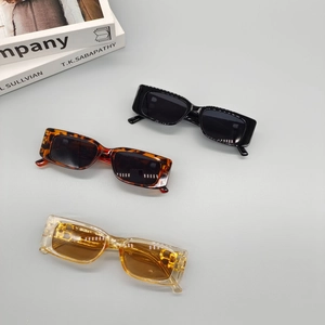 Retro rectangle sunglasses in black, tortoiseshell and amber colors on a clean background