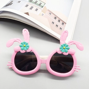 Detail of pink rabbit-shaped sunglasses for kids with cute floral accents and 3D ears