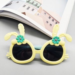 Detail of yellow rabbit ear cartoon sunglasses for kids with blue temples and flower accents