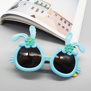 Close-up of light blue kids sunglasses with rabbit ears and sunflower details