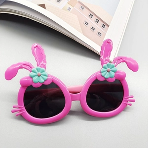 Close-up of pink rabbit-shaped children's polarized sunglasses with 3D ears and floral detail