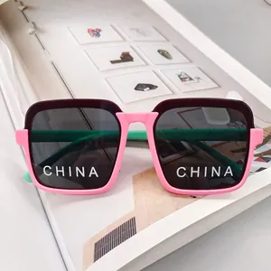 Detail of kids square sunglasses with tricolor frame and dark UV protective lenses