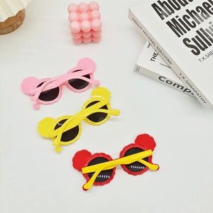 Close-up of kids cartoon round sunglasses featuring adorable mouse ear frame decorations