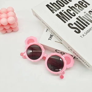 Detail of pink polarized kids sunglasses with cute cat ears on a clean pastel background