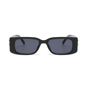 Retro narrow rectangular black sunglasses with dark lenses and gold metal details on temples