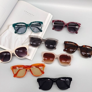 Retro oval sunglasses in various colors displayed on a stylish magazine background
