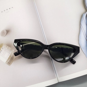 Detail of black cat-eye sunglasses with dark green lenses and leg size specifications