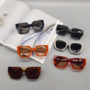 Fashionable oversized polygonal sunglasses in multiple colors on a stylish magazine