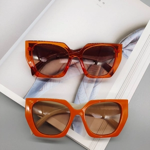 Fashionable oversized polygon sunglasses with amber and orange frames and gradient lenses