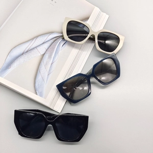Three pairs of stylish thick-frame polygonal sunglasses in beige, navy, and black colors