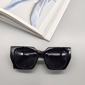 Detailed top view of black geometric cat-eye sunglasses with thick frame and dark lenses