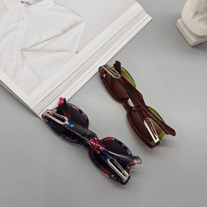 Detail of square sunglasses with thick marble texture frames and silver metal accents