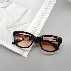 Macro detail of retro square sunglasses with thick black frames and tinted lenses