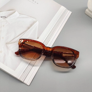 Detail of vintage tortoise shell rectangular sunglasses on an aesthetic magazine layout