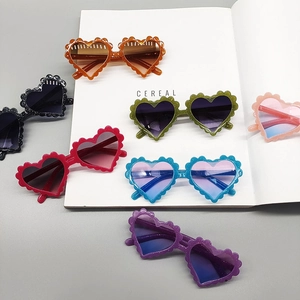 Kids heart shaped sunglasses with scalloped edge frames in multiple vibrant colors