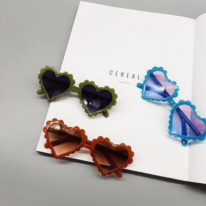 Three-pack heart-shaped kids sunglasses with wavy petal frames in green orange and blue