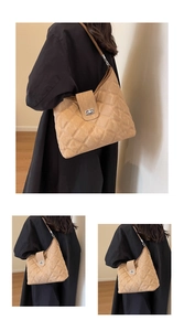 Detail of beige quilted PU leather shoulder bag with silver twist lock and smooth texture