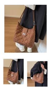 Detail view of brown quilted PU leather shoulder bag with vintage texture and metal lock