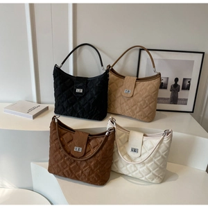 Quilted handbags in black, beige, coffee, and cream with metallic twist locks in a group shot