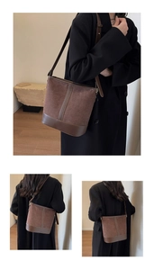 Detail of brown suede bucket bag showing textured stitching and adjustable shoulder strap