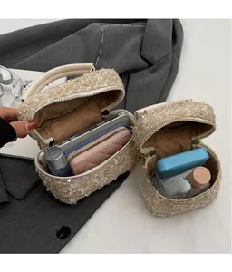 Detail of tweed bucket bags set showing spacious interior for cosmetics and accessories