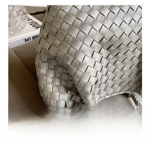 Macro shot of silver woven leather texture and detailed craft on a French tote bag