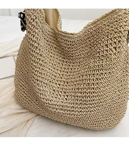 Detail of hand-woven straw tote bag with checkered ribbon and soft fabric lining
