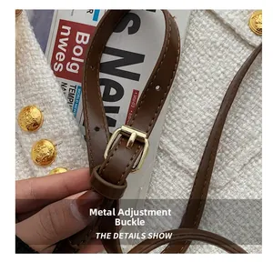 Macro detail of adjustable golden buckle on a premium brown leather shoulder strap