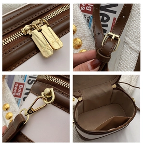 Close-up of golden dual zippers and tweed texture on a retro crossbody bag
