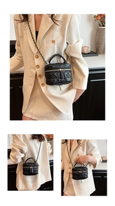 Detail of mini vanity case bag with heart-quilted pattern and gold chain strap