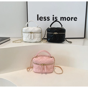 Three mini heart quilted box bags in white, black and pink with gold chain straps