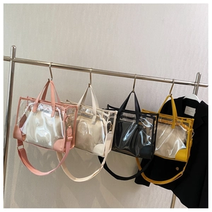 Detail view of clear PVC tote bags with inner pouches and adjustable shoulder straps