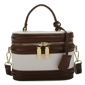 Retro contrast color crossbody bag with top handle and gold hardware on white background
