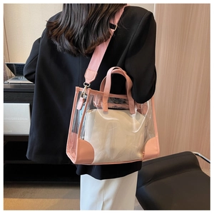 Close-up of pink jelly tote bag with inner pouch and wide fabric shoulder strap