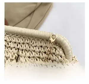 Detail showing natural woven texture and gold-tone chain strap with durable lobster clasp