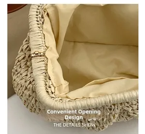 Detail shot of the woven clutch bag featuring a wide opening and secure metal hinge closure