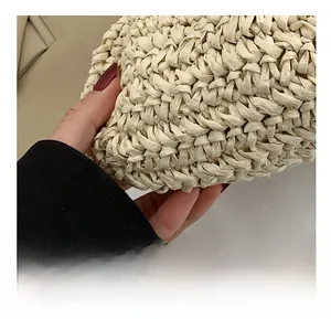 Close-up of tight woven texture on cream beige crossbody bag showing premium craftsmanship