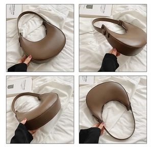 Detail view of coffee brown crescent hobo bag showing front side and bottom leather texture