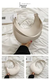 Detail view of versatile white matte leather crescent underarm bag on textured background