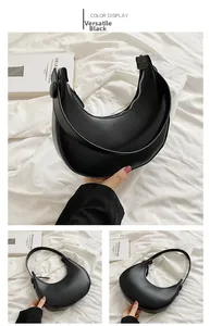 Detail of a black crescent shoulder bag with smooth matte finish and metal zipper closure