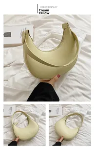 Detail view of the creamy yellow crescent shoulder bag with smooth synthetic leather