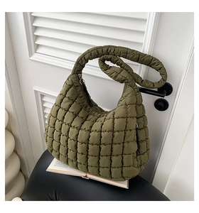 Detail of army green quilted cloud bag with padded shoulder strap and zipper closure