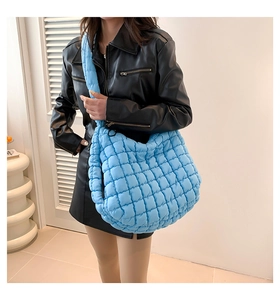 Blue quilted puff tote bag featuring large capacity and soft padded shoulder strap